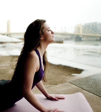 woman in black tank top sitting on concrete floor during daytime