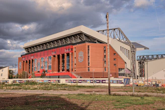 a stadium with a cloudy sky in the background