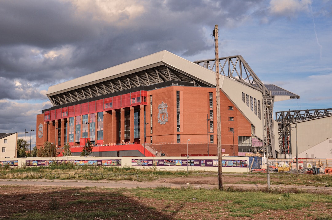 a stadium with a cloudy sky in the background,