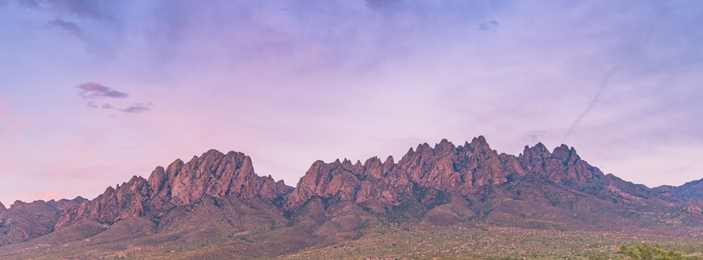 brown rocky mountain under white cloudy sky during daytime