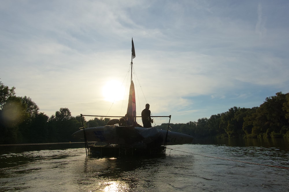 man riding on boat on lake during daytime
