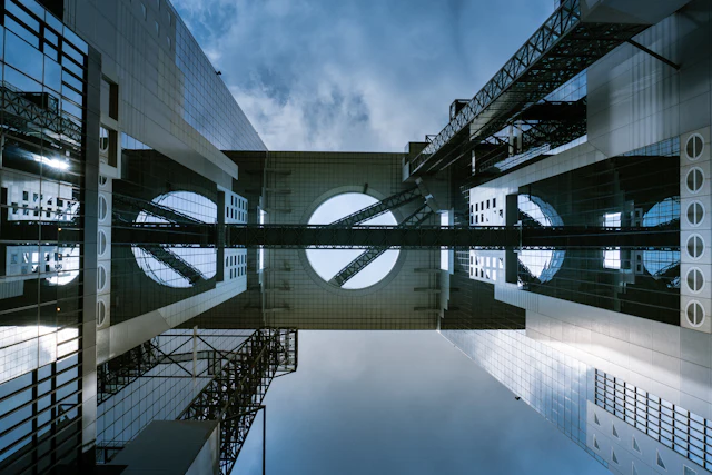 Looking straight up between the twin towers of the Umeda Sky Building, connected by its circular floating garden observatory bridge.