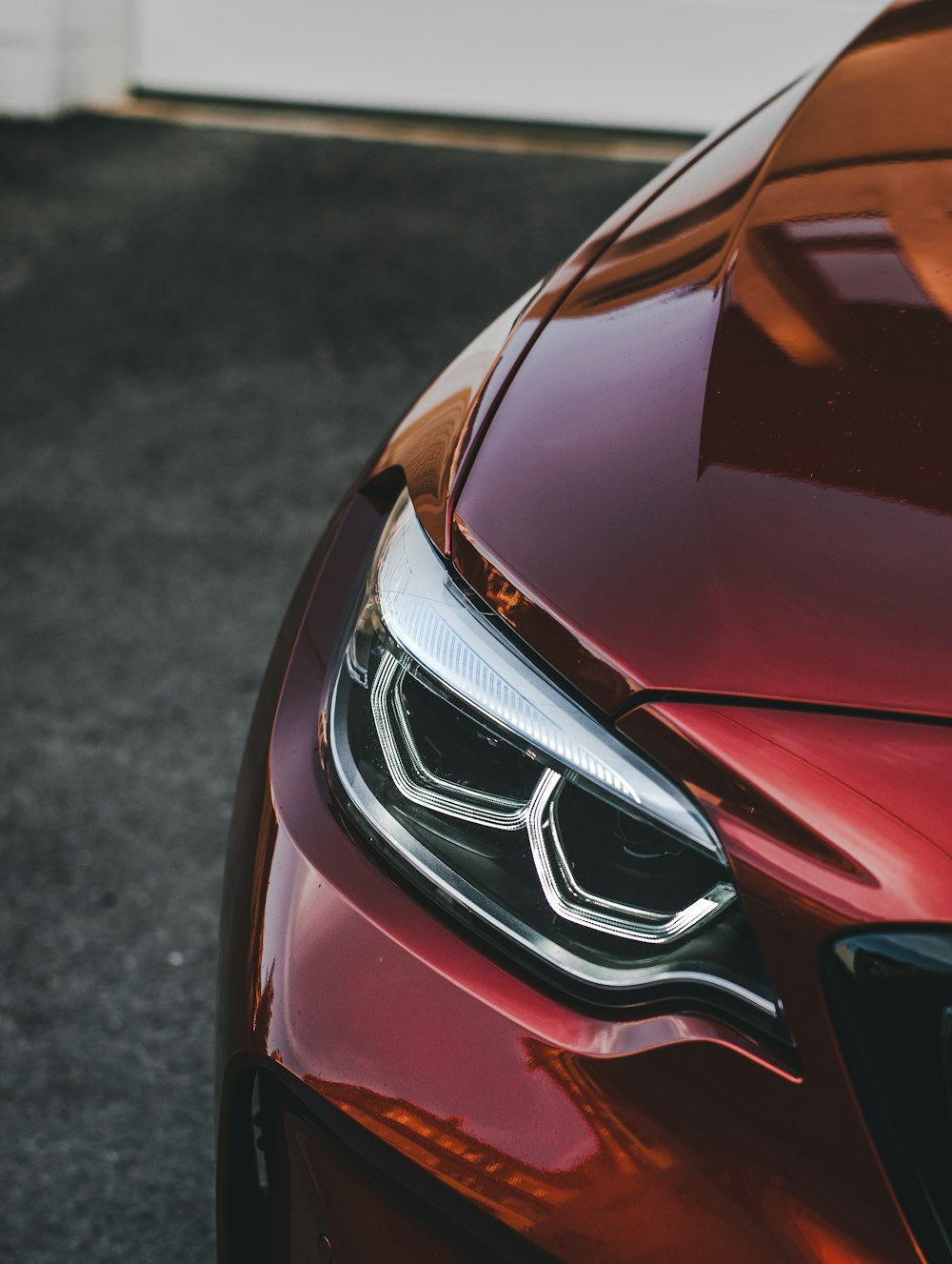 red mercedes benz car on gray asphalt road