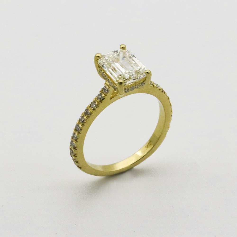 gold ring on white surface