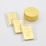 A collection of gold items including stacked Canadian maple leaf coins and several half-ounce fine gold bars labeled 'Credit Suisse' in protective packaging laid on a flat surface.