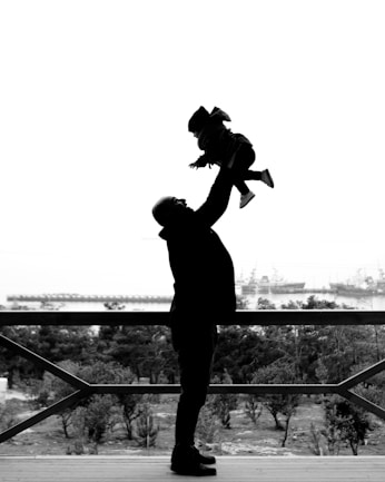 man in black jacket and pants standing on the stairs
