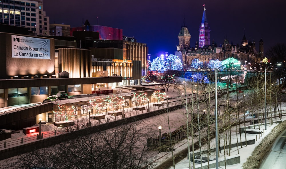 city buildings with lights turned on during night time