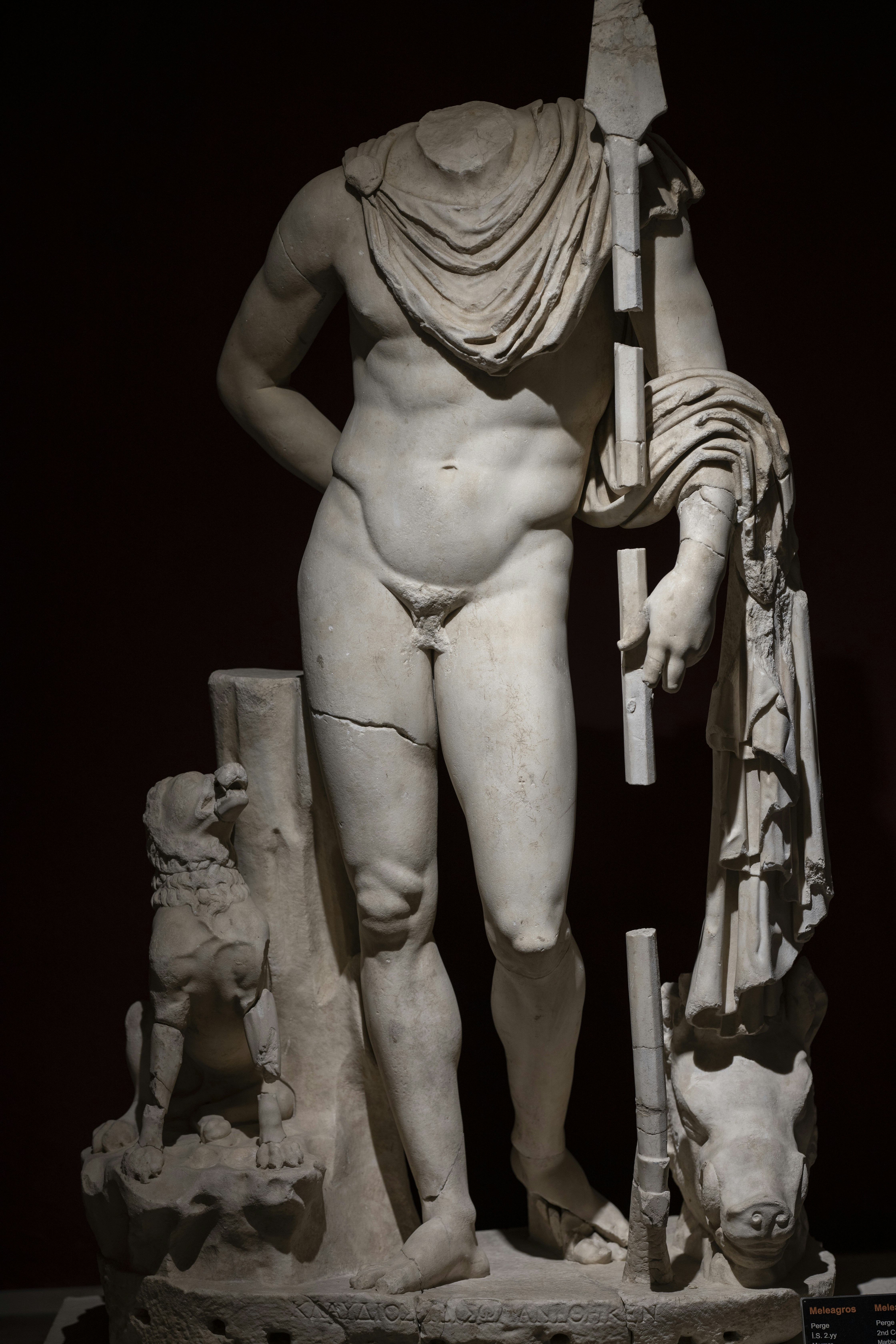 woman holding stick statue with black background