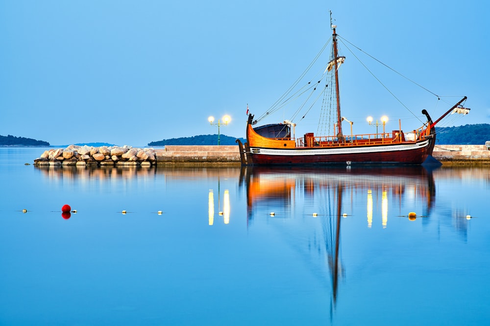 brown boat on body of water during daytime