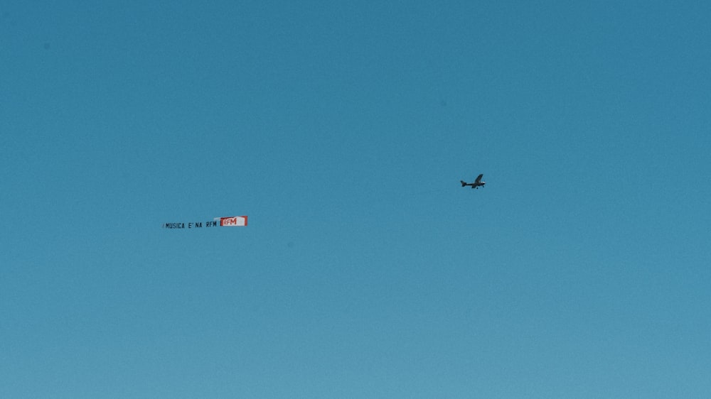 airplane in mid air under blue sky during daytime