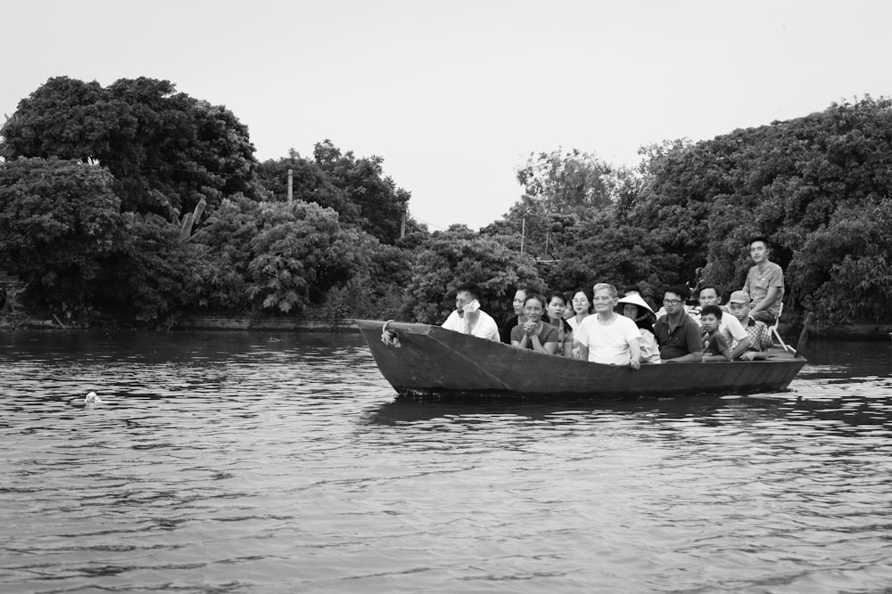 people riding on boat on lake during daytime