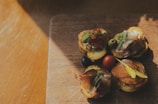 Close-up of a freshly prepared savory snack served on a rustic wooden board.