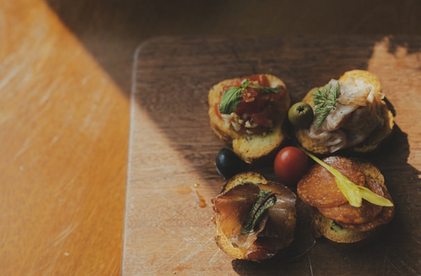 Close-up of freshly prepared savory snacks on a wooden board.