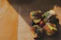 Close-up of a rustic wooden board with slices of alpine cheese and speck arranged invitingly.