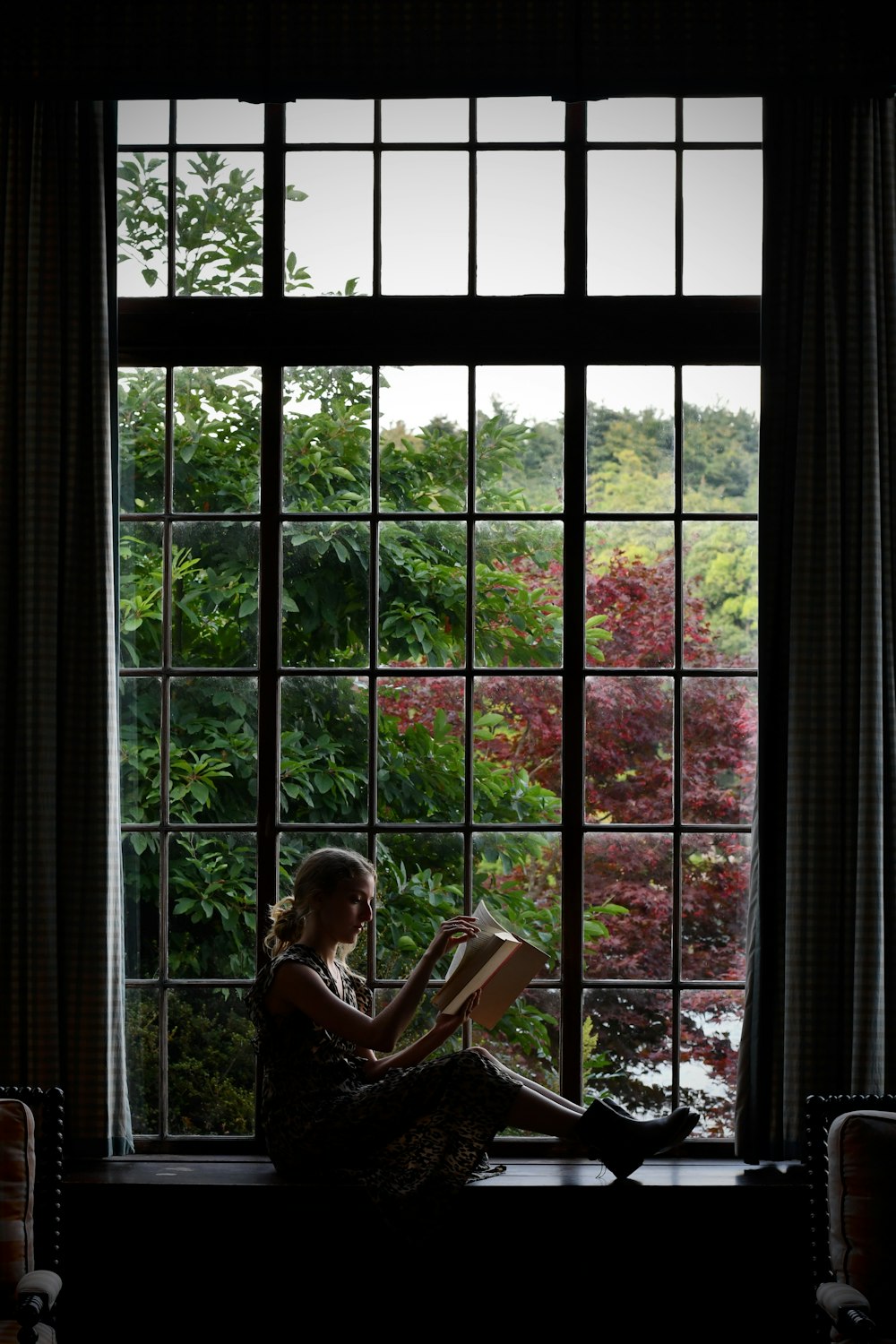 woman in black and white dress reading book