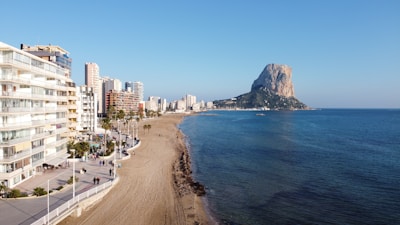 city buildings near sea under blue sky during daytime