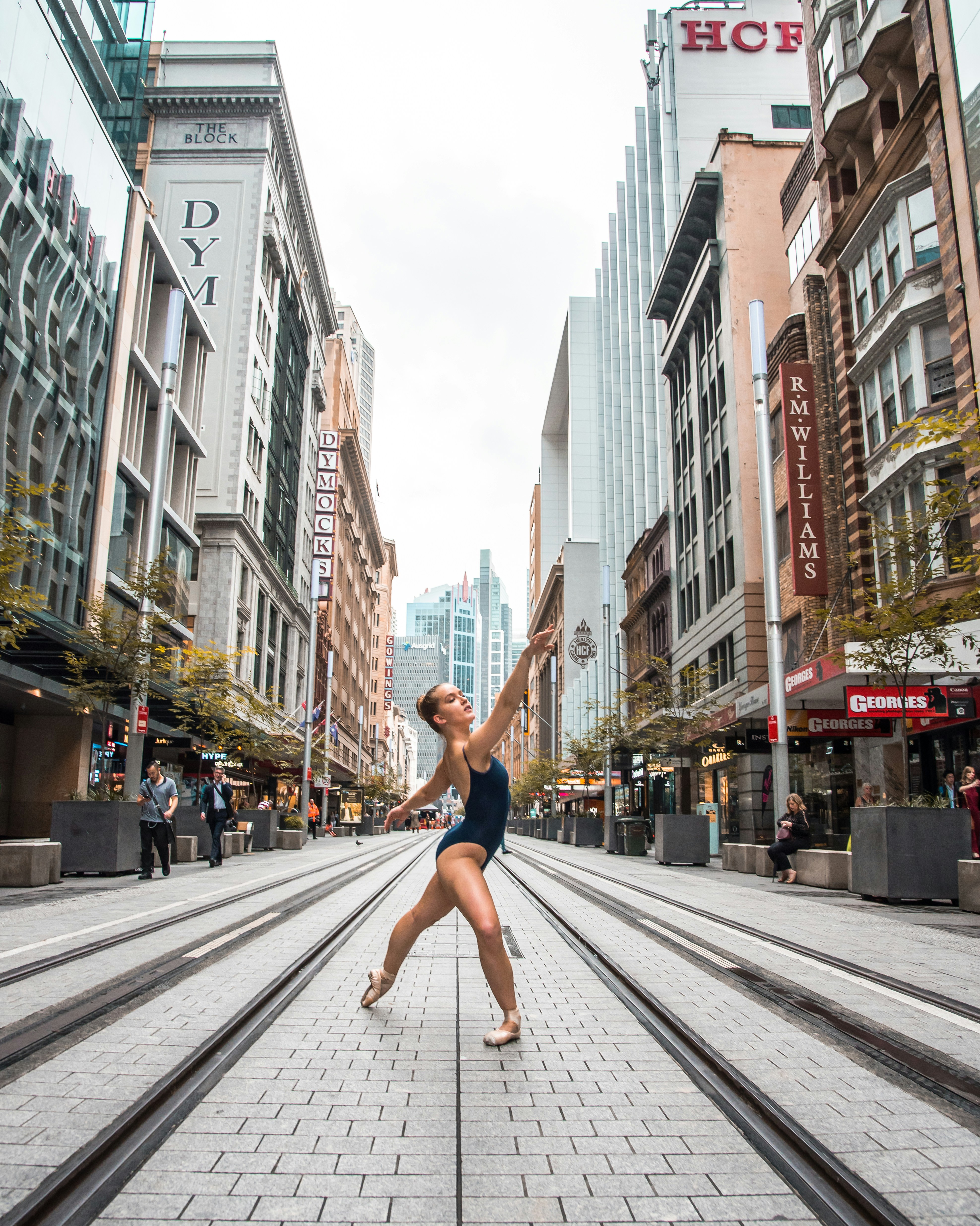 man in red shorts jumping on the street during daytime