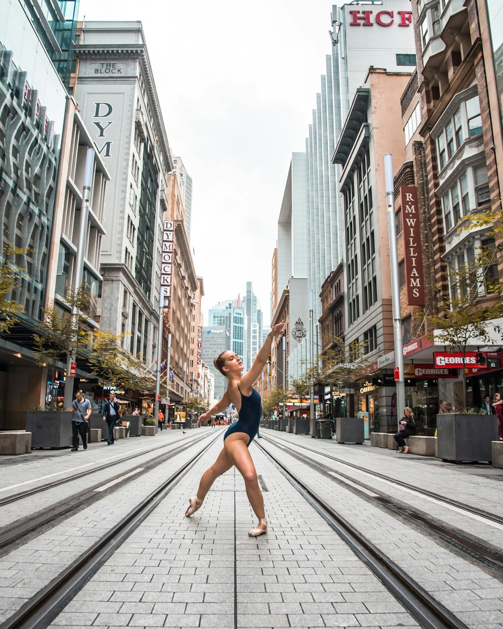 man in red shorts jumping on the street during daytime