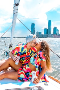 woman in white orange and green stripe shirt sitting on white boat during daytime