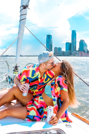 woman in white orange and green stripe shirt sitting on white boat during daytime