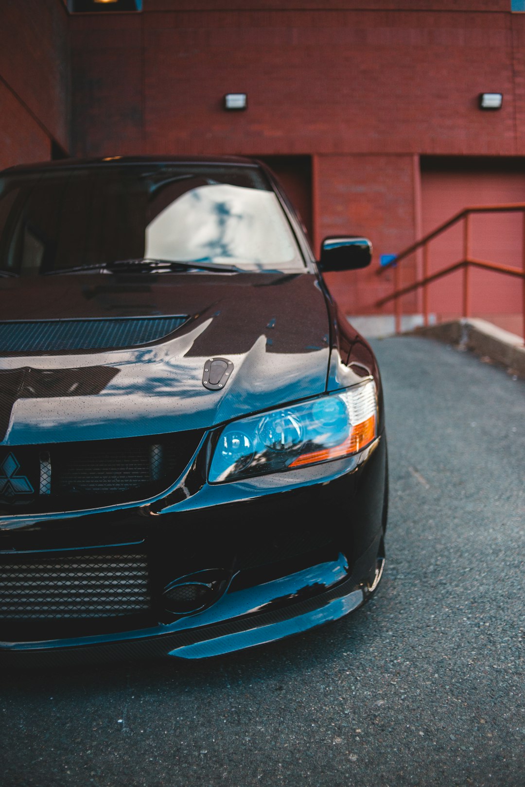 blue bmw m 3 parked on sidewalk during daytime