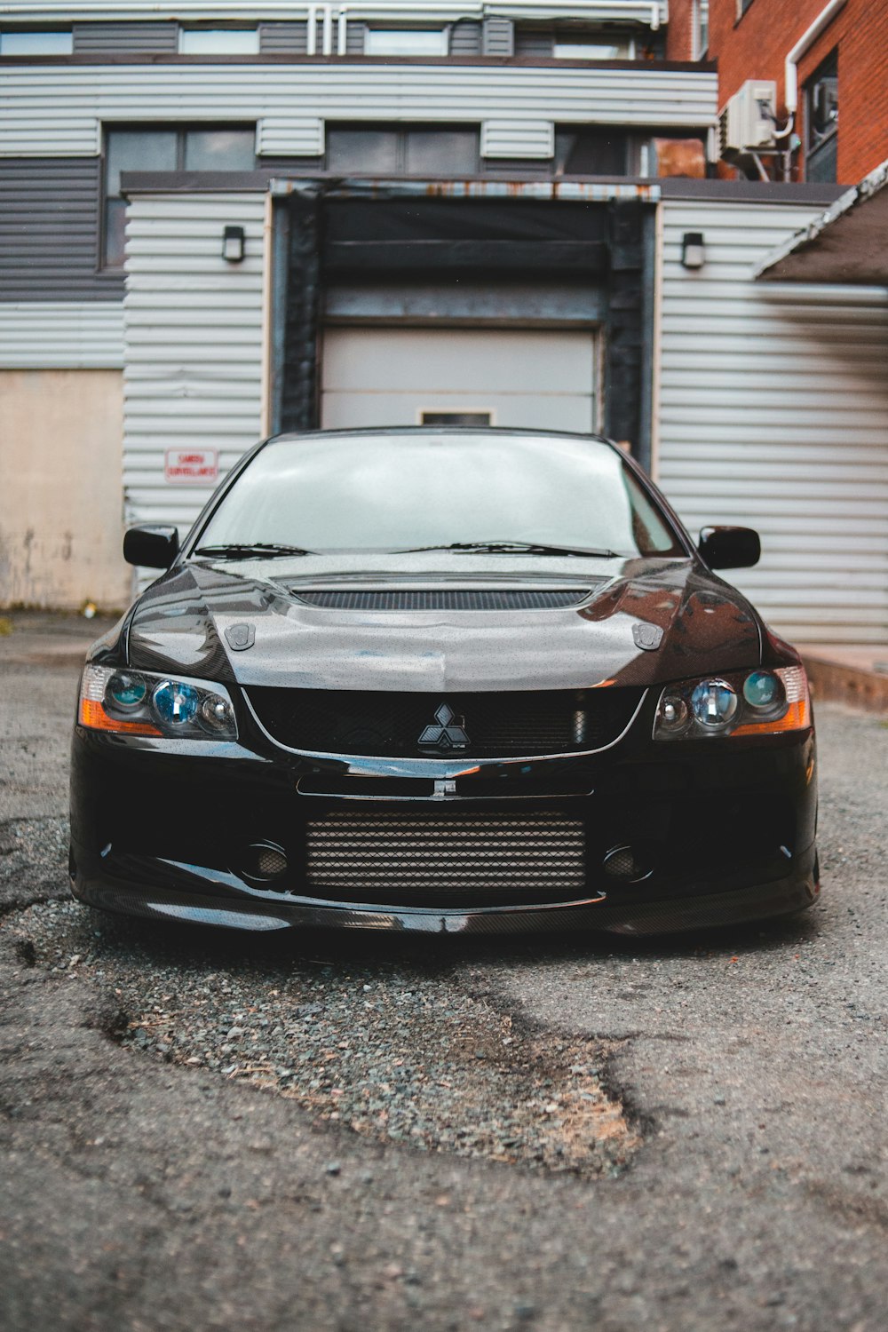 black bmw car parked beside white building