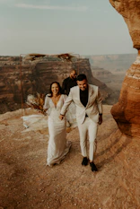 A joyful couple exchanging vows outdoors with Jimmy officiating the ceremony.