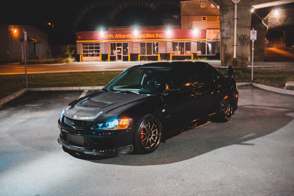 black bmw m 3 parked on sidewalk during night time