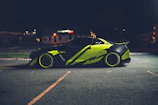 Neon-lit sports car mod showcased on a dark city street at night.