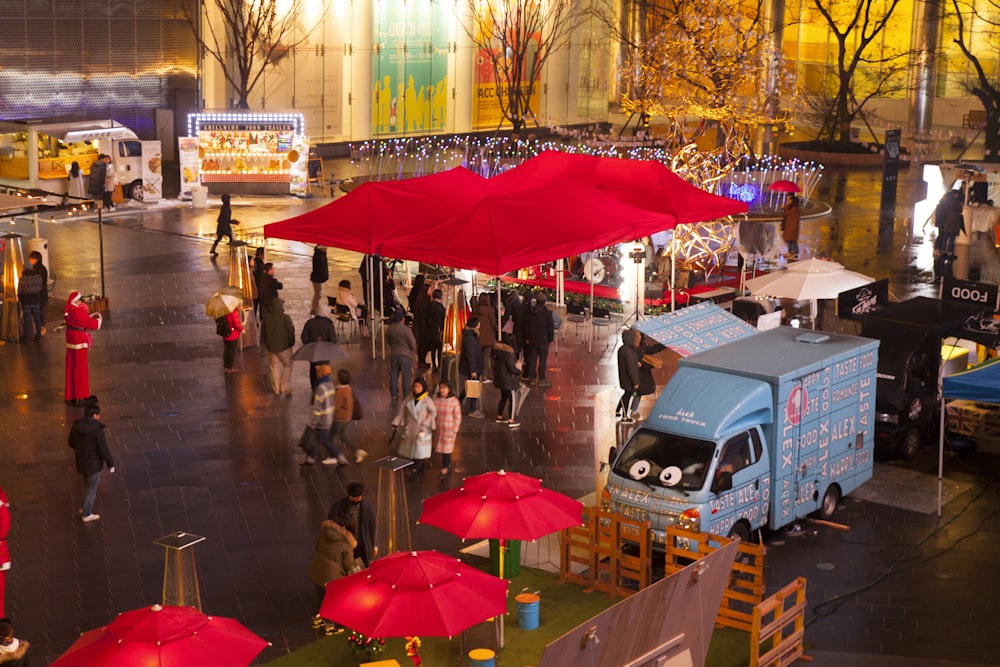 people walking on street with umbrella during daytime