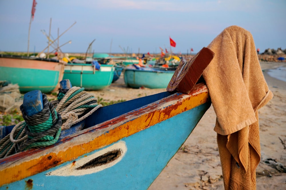 blue and white boat on beach during daytime