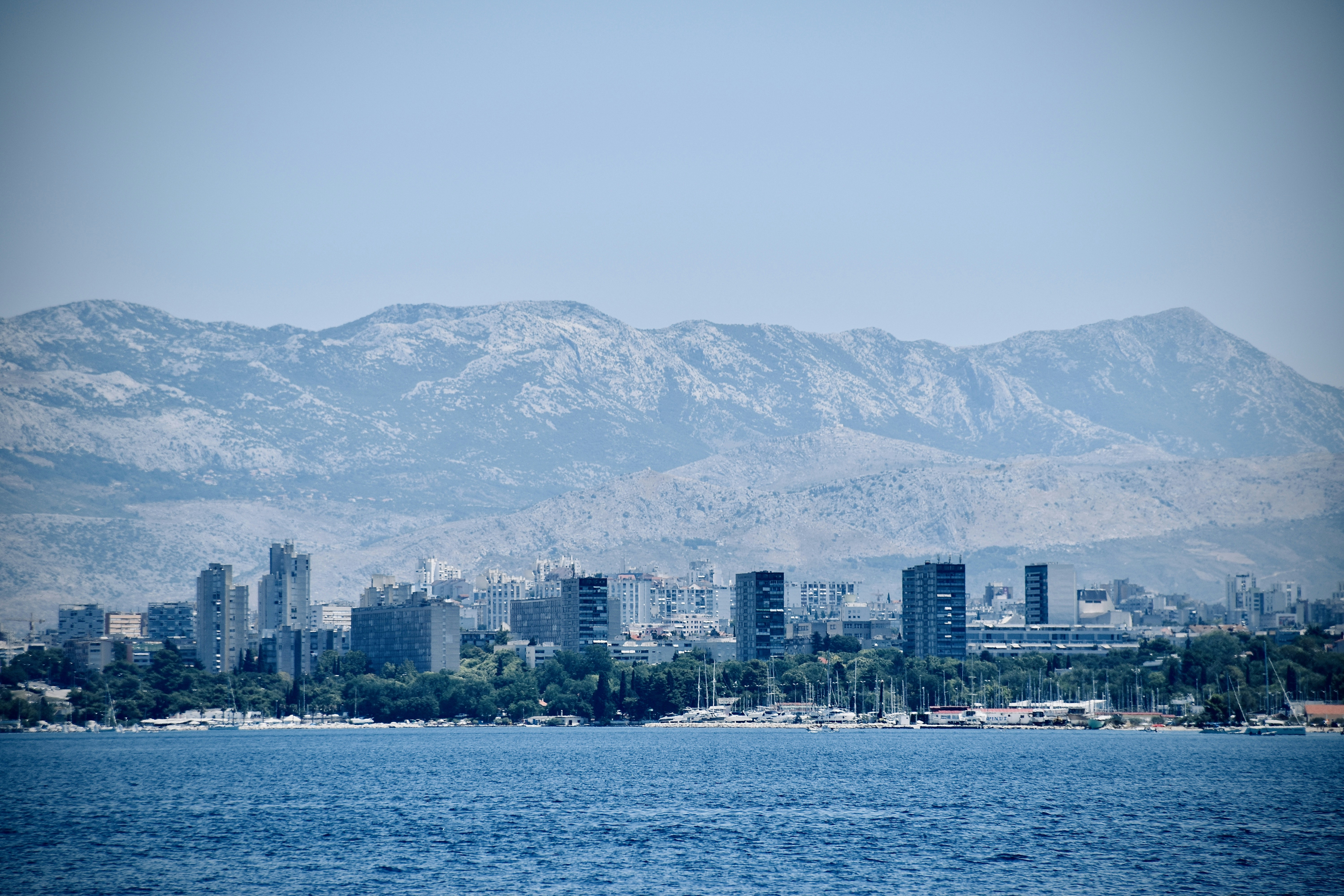 city skyline across body of water during daytime
