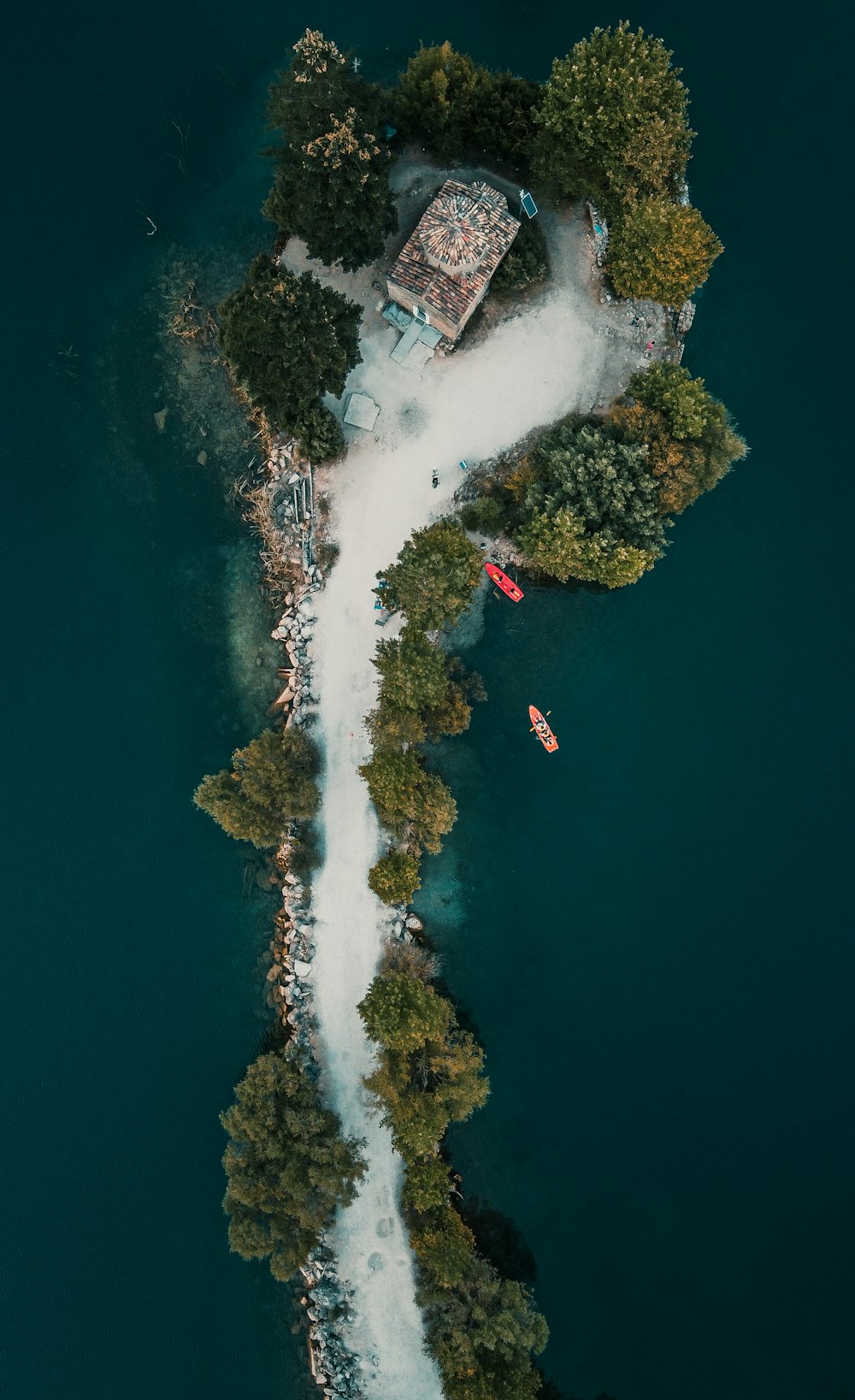 aerial view of white and red house on island during daytime