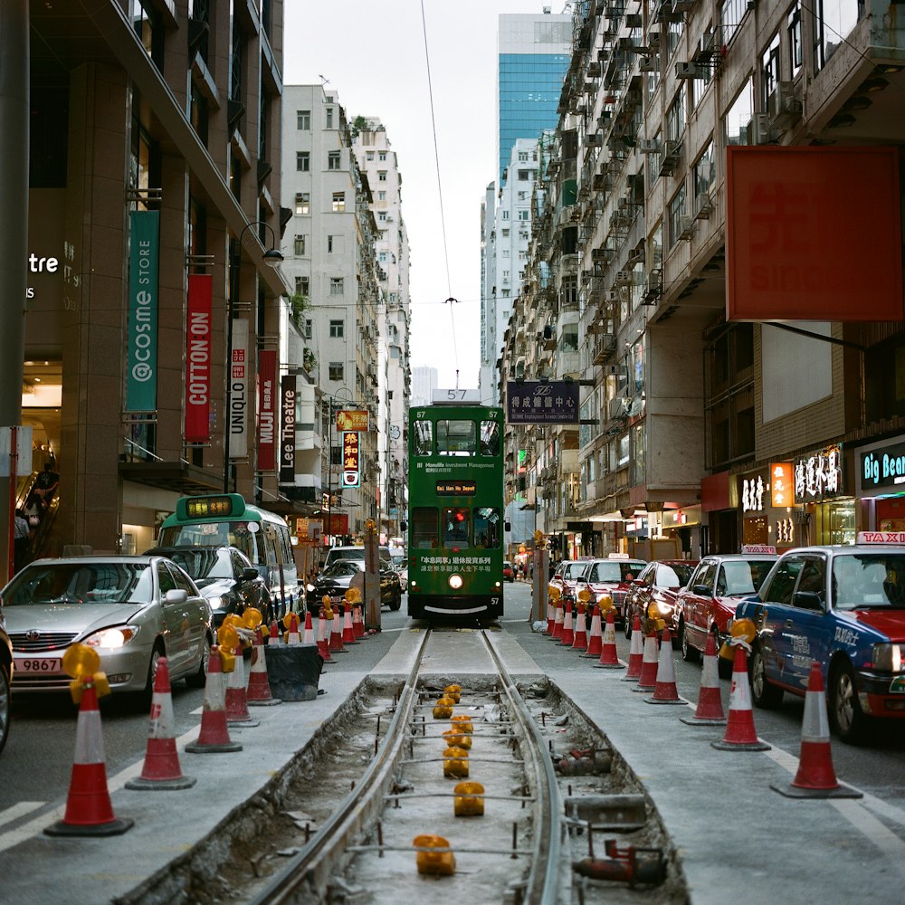 green train on the street during daytime