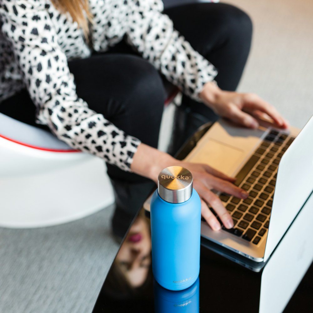 woman in black pants sitting on white chair