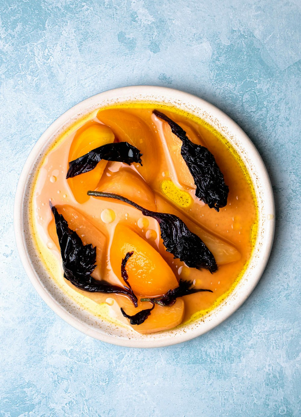 a white bowl filled with food on top of a blue table