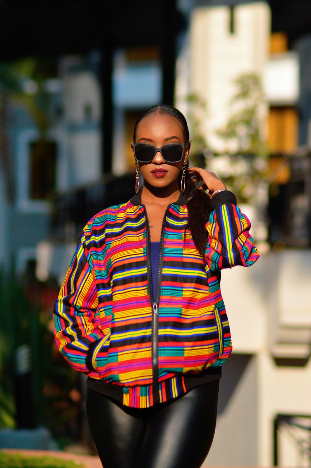 woman in red blue and white striped long sleeve shirt wearing black sunglasses