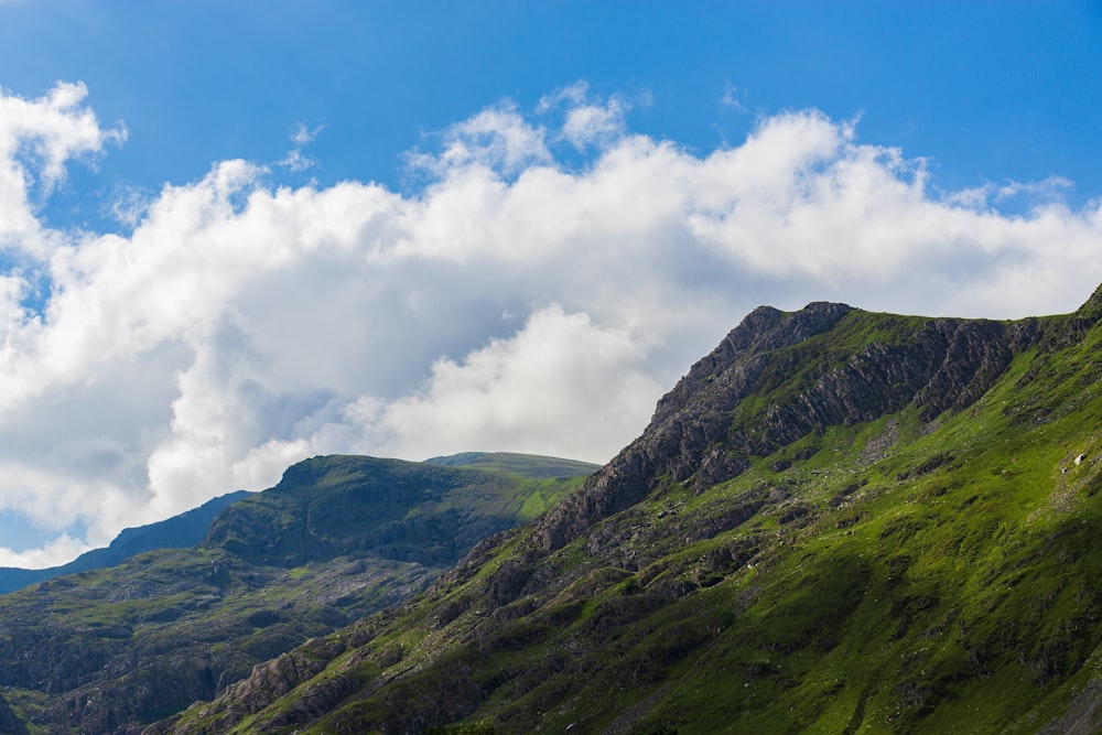 green mountain under white clouds during daytime