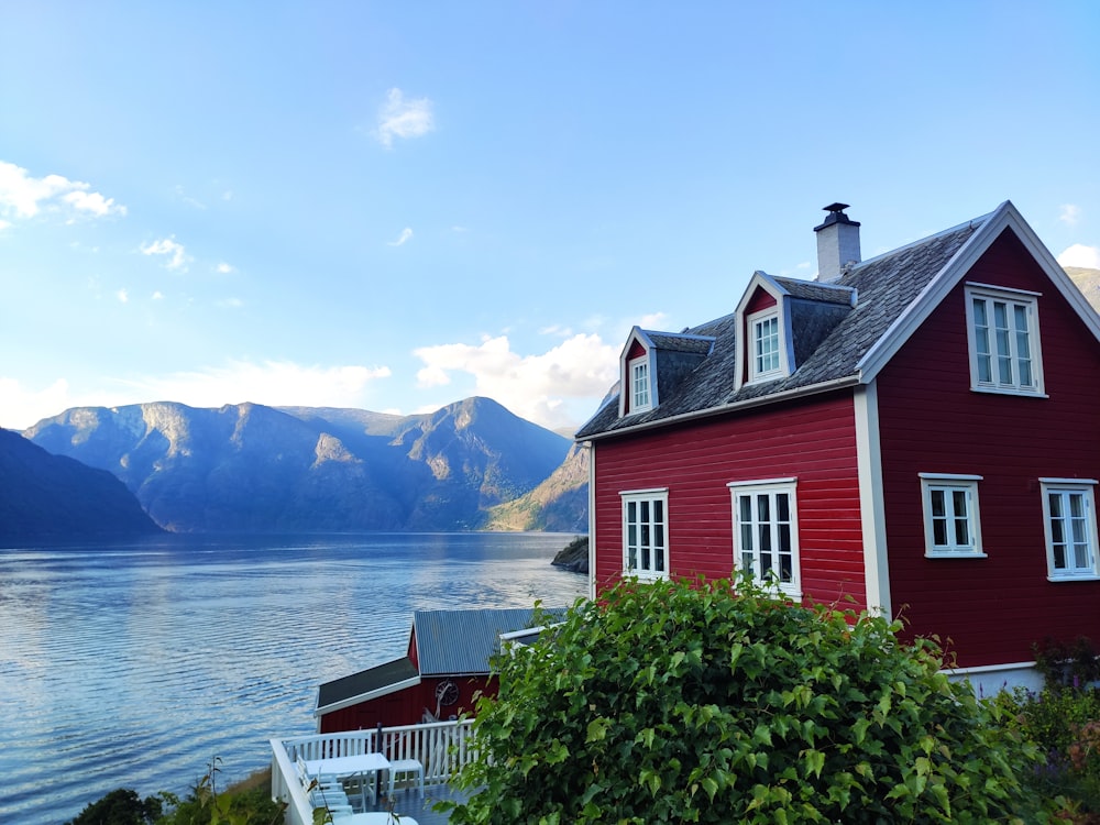 red and white house near body of water during daytime