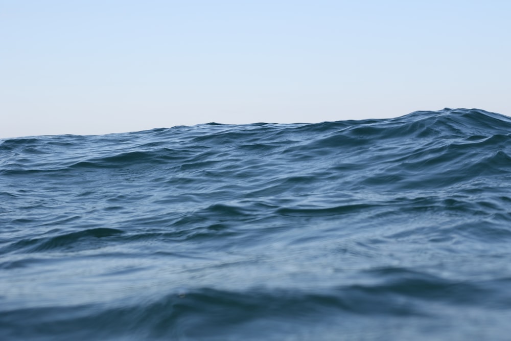 blue ocean water under white sky during daytime