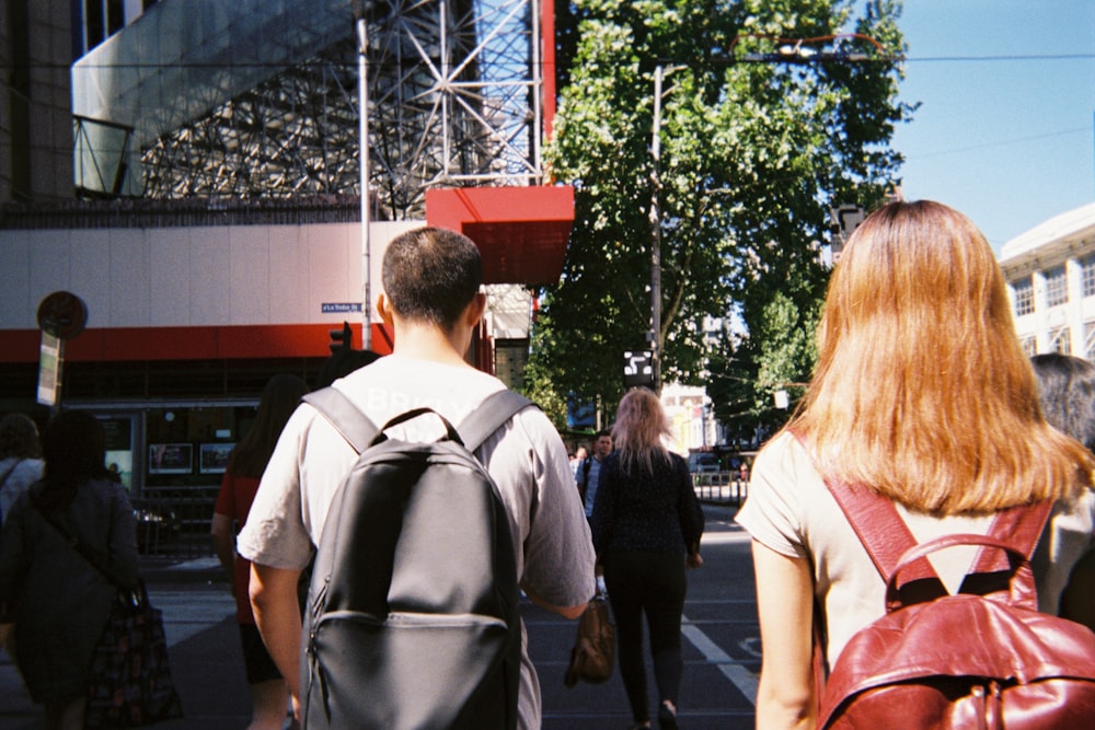 man in white shirt standing beside woman in pink shirt