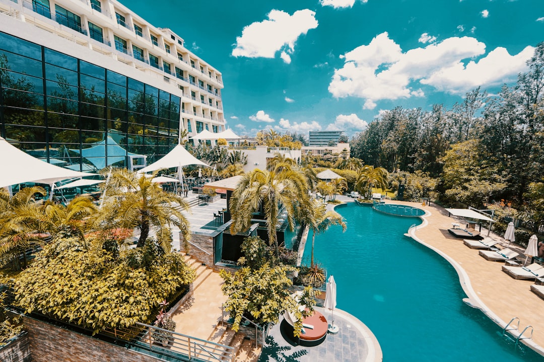 white and blue concrete building near green trees and body of water during daytime, Marriott Hotel Kigali<p></figure>Credits: Franck Axel