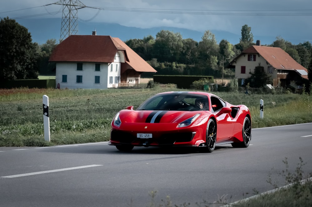 red ferrari sports car on road during daytime