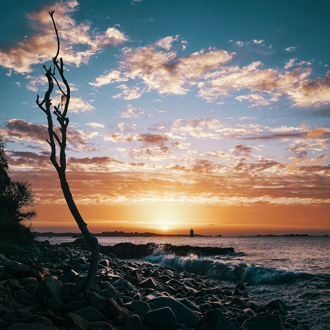 body of water under blue sky during sunset