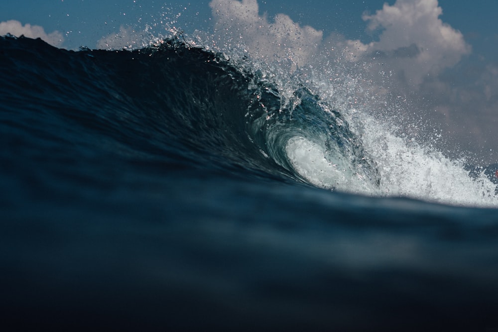 a man riding a wave on top of a surfboard