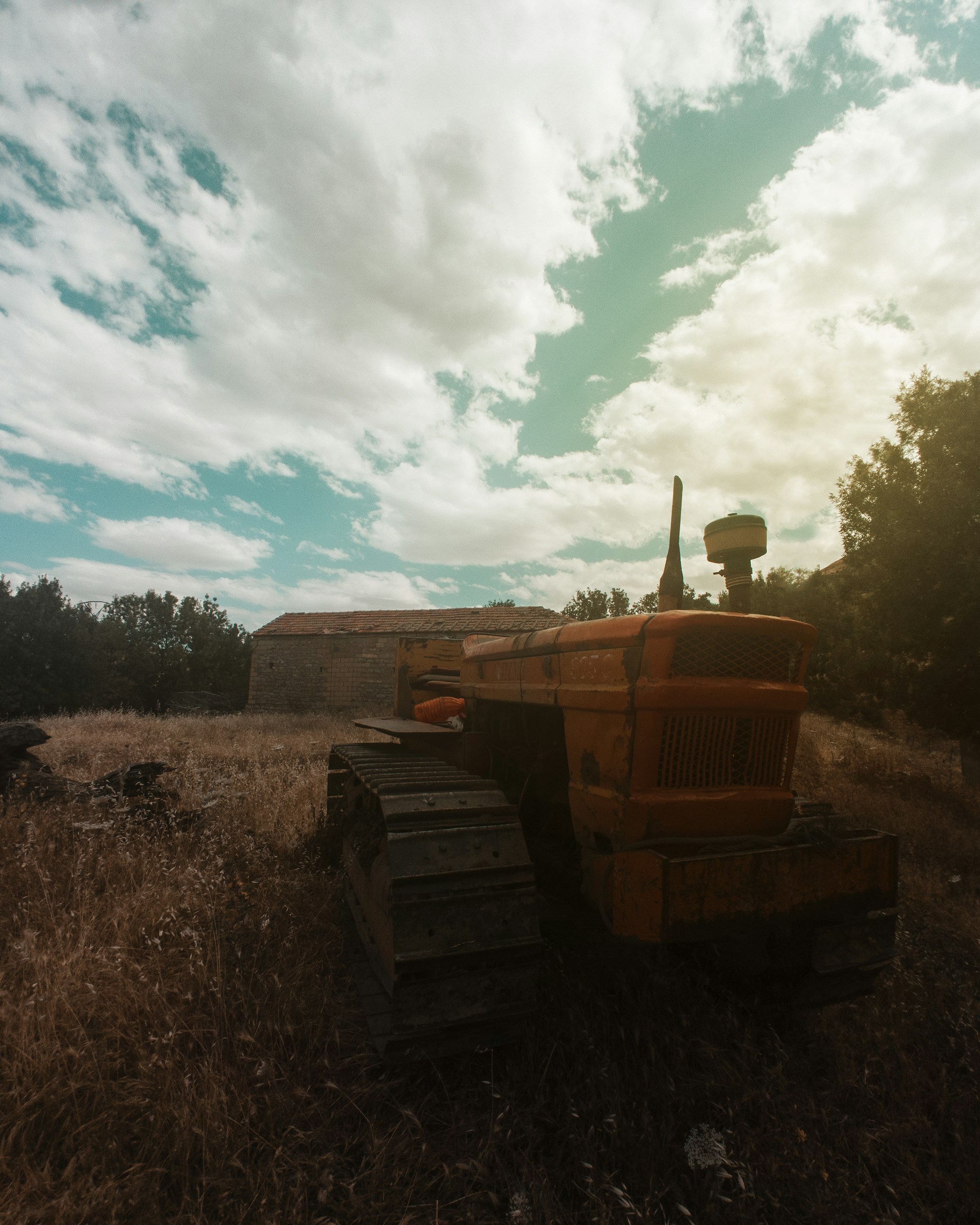 a tractor is parked in a field of dry grass