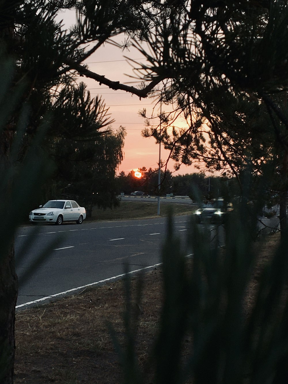 cars parked on side of the road during sunset