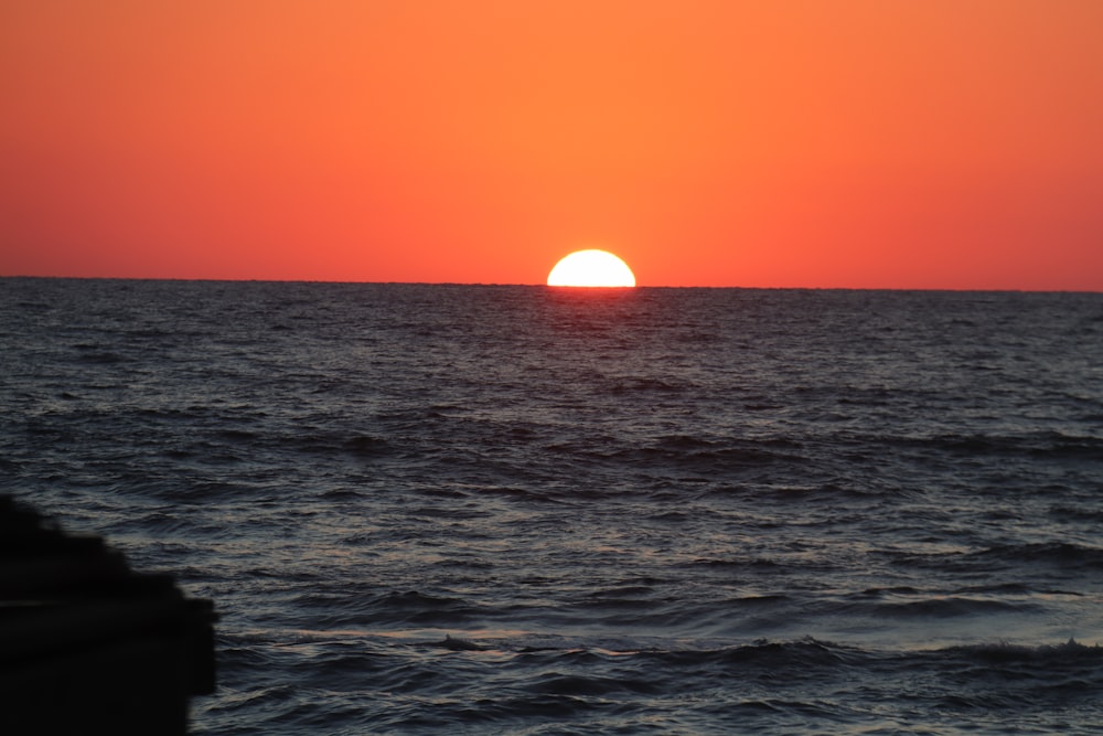 body of water during sunset