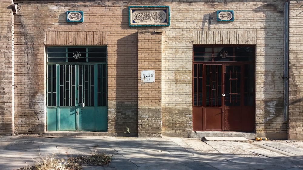 an old brick building with a green door