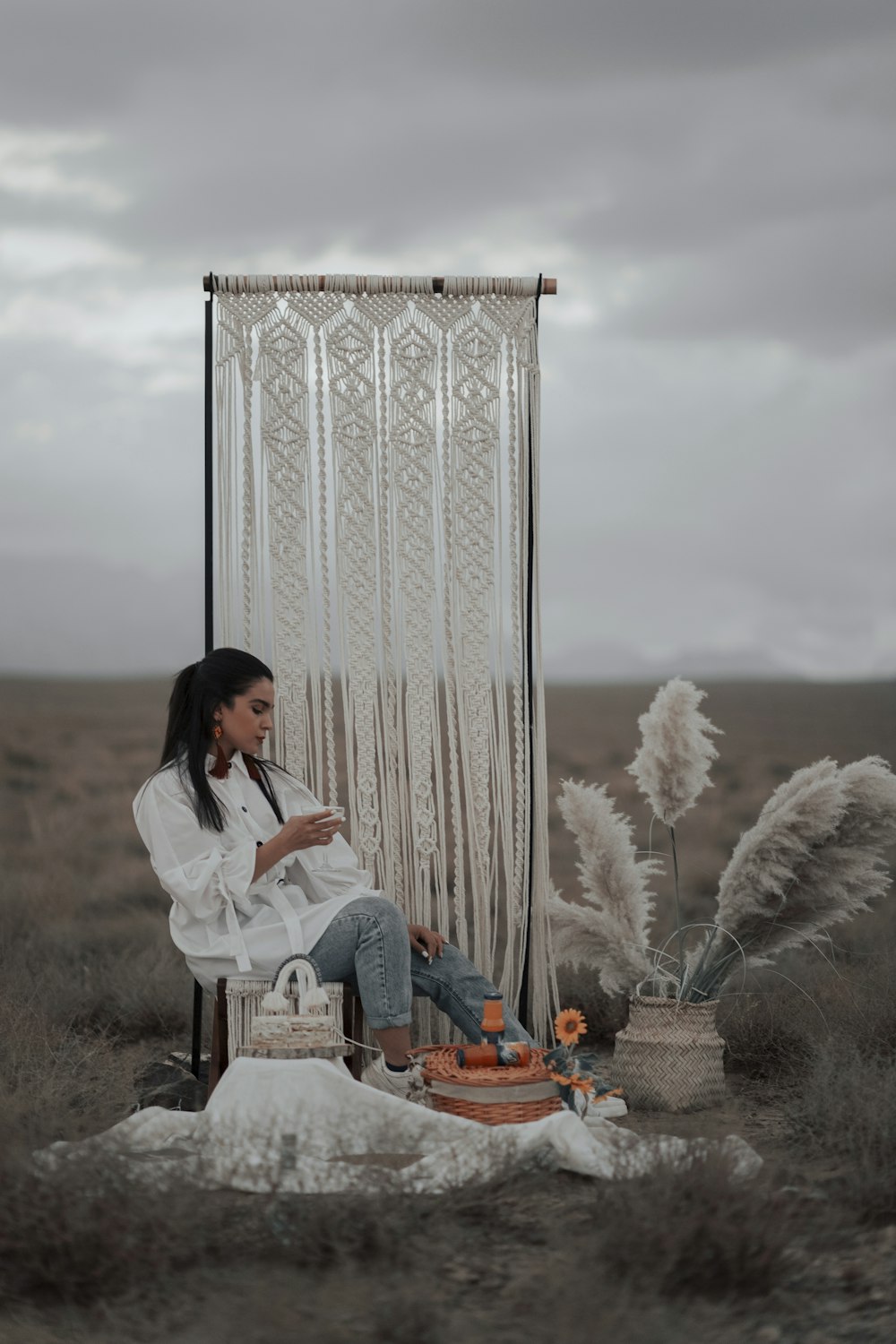 woman in white long sleeve shirt sitting on brown wooden chair